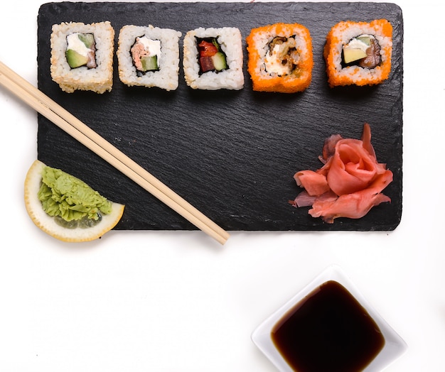 Delicious sushi on black plate