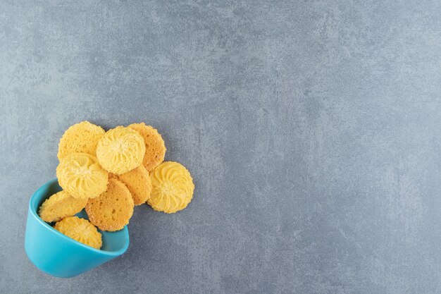 Delicious sweet biscuits in blue bowl.