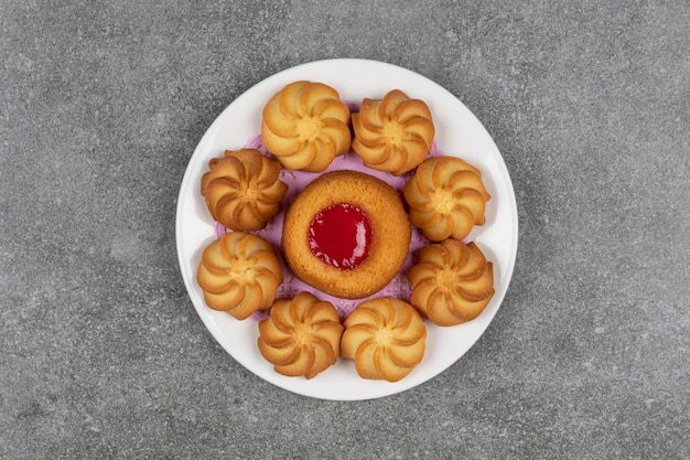 Delicious sweet biscuits on white plate.