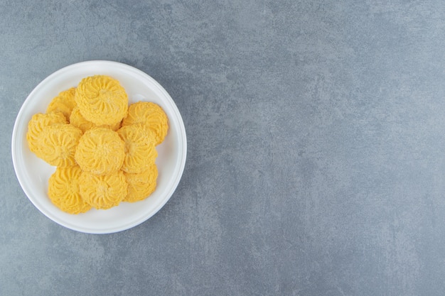 Delicious sweet biscuits on white plate.