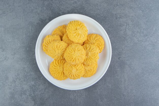 Delicious sweet biscuits on white plate.