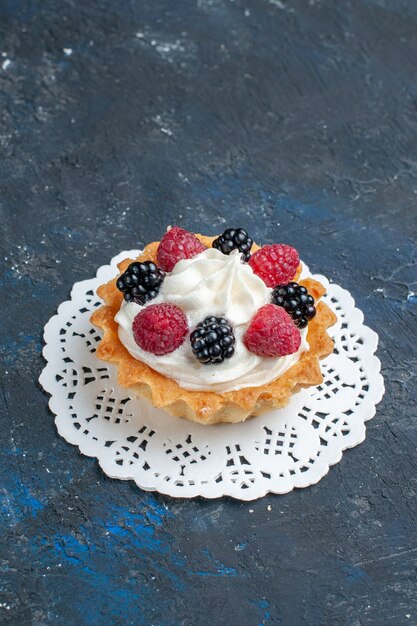 delicious sweet cake with different berries and cream on dark-grey desk, fruit berry cake biscuit sweet bake