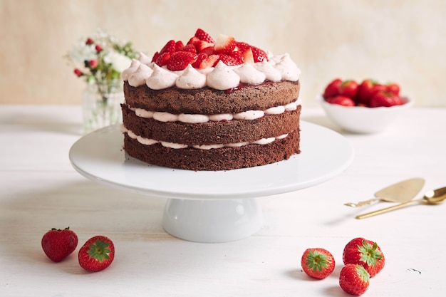 Delicious and sweet cake with strawberries and baiser on a plate
