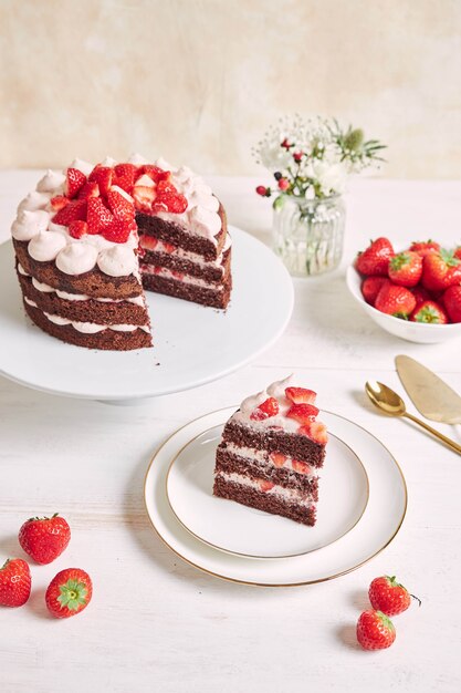 Delicious and sweet cake with strawberries and baiser on a plate