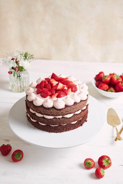 Delicious and sweet cake with strawberries and baiser on a plate