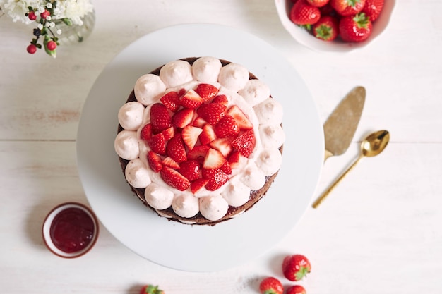 Delicious and sweet cake with strawberries and baiser on plate