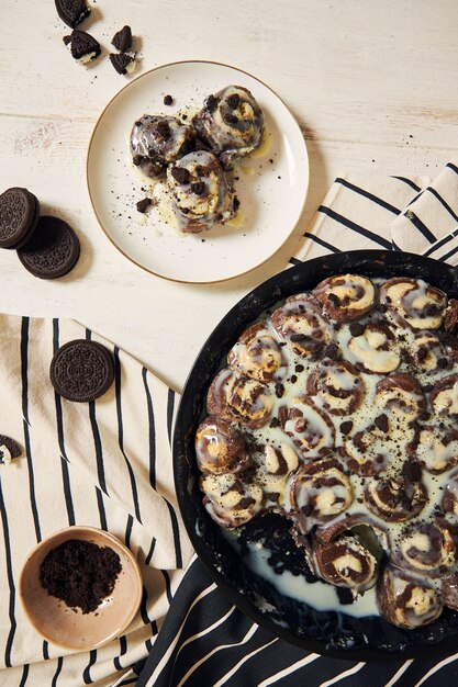 Delicious and sweet cinnamon rolls with white cream  in a plate