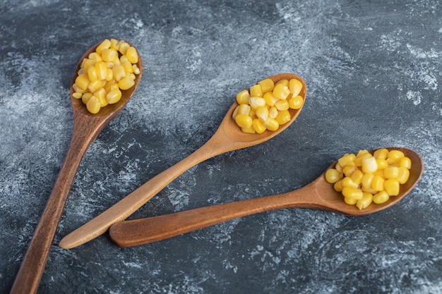 Delicious sweet corn on wooden spoons.