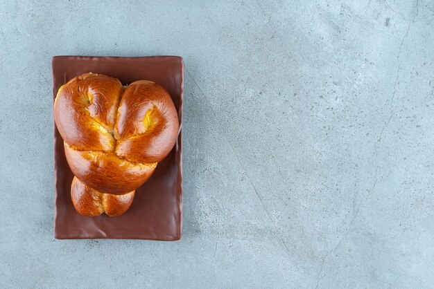 Delicious sweet pastry on brown plate.