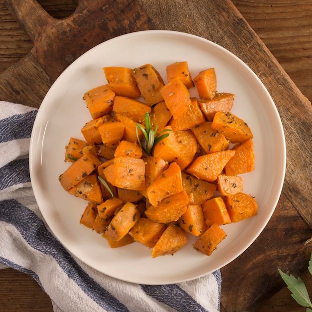 Delicious sweet potatoes on plate flat lay