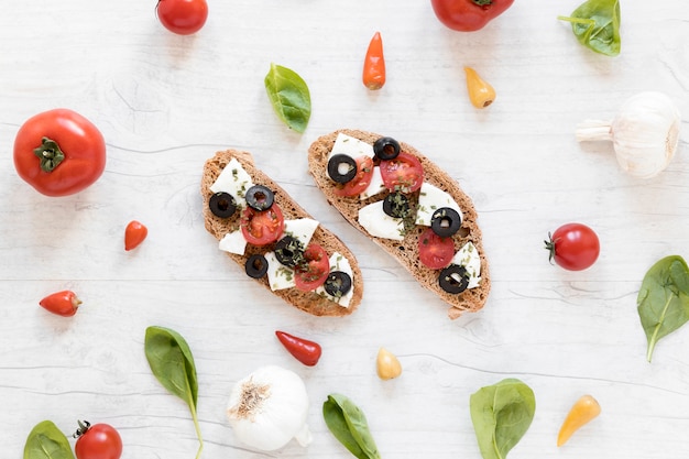 Delicious tasty bruschetta surrounded by healthy ingredient