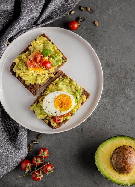 Delicious toast with veggie cream flat lay