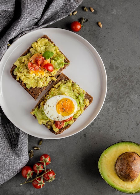 Delicious toast with veggie cream flat lay