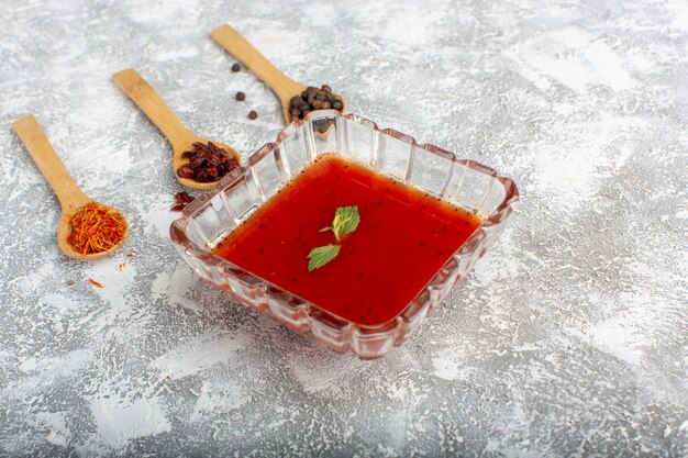 delicious tomato sauce inside glass plate on grey, soup meal vegetable food