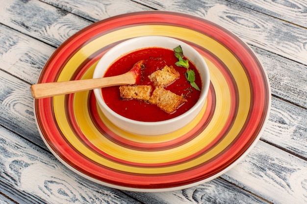 delicious tomato soup with rusks inside on the grey, soup food meal dinner