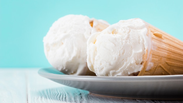 Delicious vanilla ice cream cones laying on plate