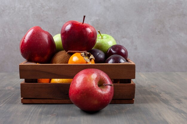 Delicious various fruits on a wooden basket. High quality photo