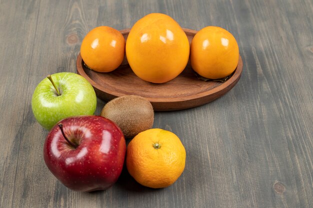 Delicious various fruits on a wooden table. High quality photo