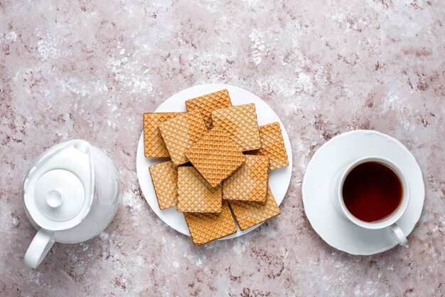 Delicious wafers and a cup of coffee for breakfast, top view