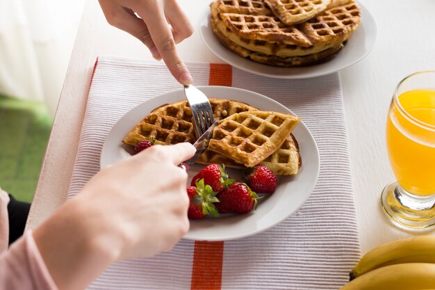 Delicious waffles with strawberries and juice