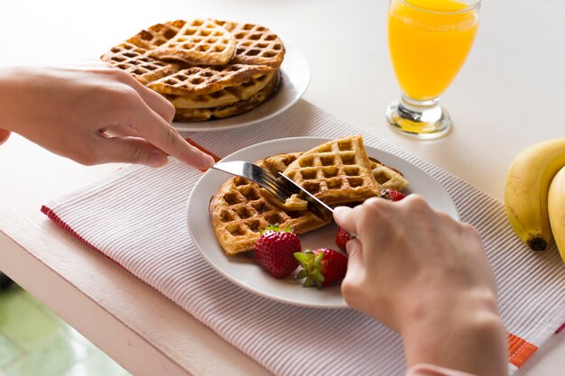 Delicious waffles with strawberries and juice