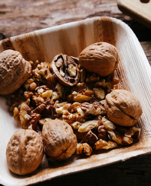 Delicious walnuts on wooden bowl