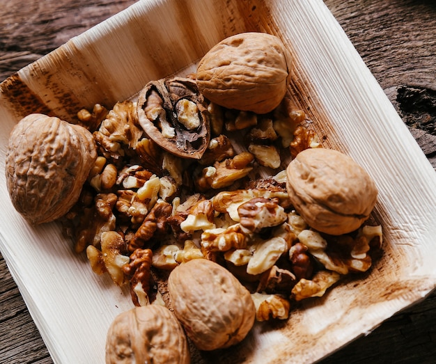 Delicious walnuts on wooden bowl