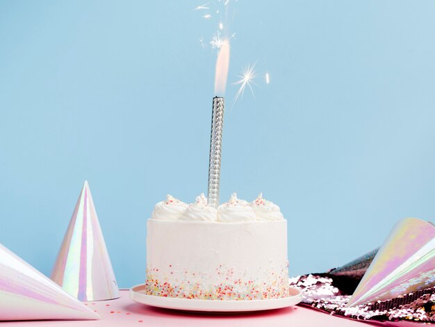 Delicious white cake with birthday hats