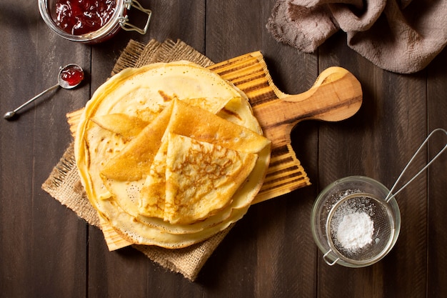 Delicious winter crepe dessert with jam and sugar