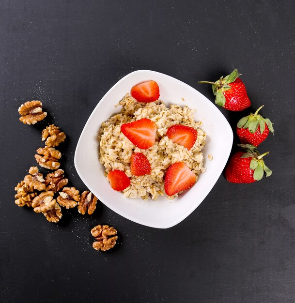 Delicious yoghurt with walnuts on rustic board