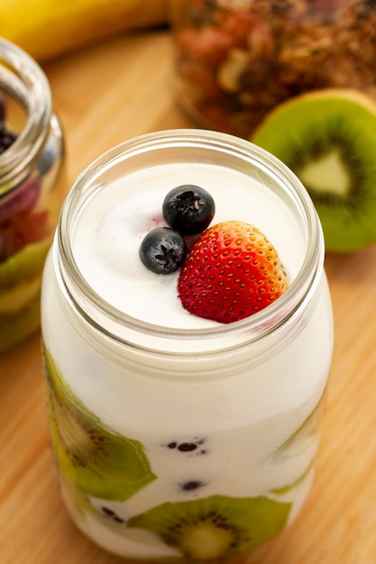 Free photo delicious yogurt with kiwi slices high angle