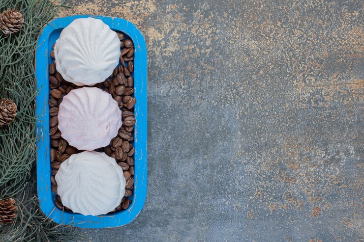 Free Photo delicious zephyr with coffee beans in a blue plate. high quality photo