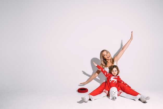 Delighted blonde woman with cute child imitating flying