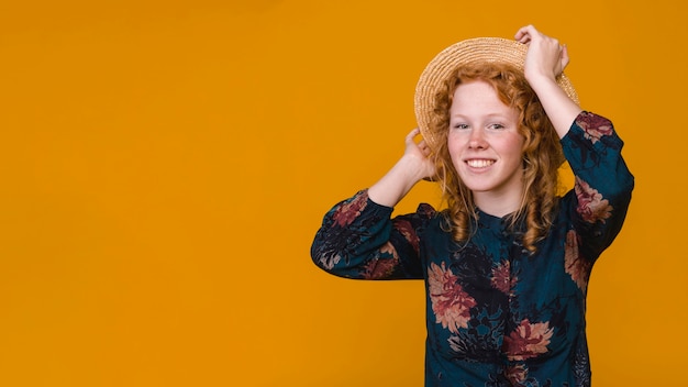 Delighted curly woman in studio with colored background