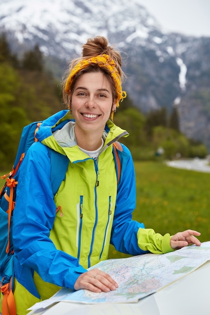 Delighted satisfied active lady studies map