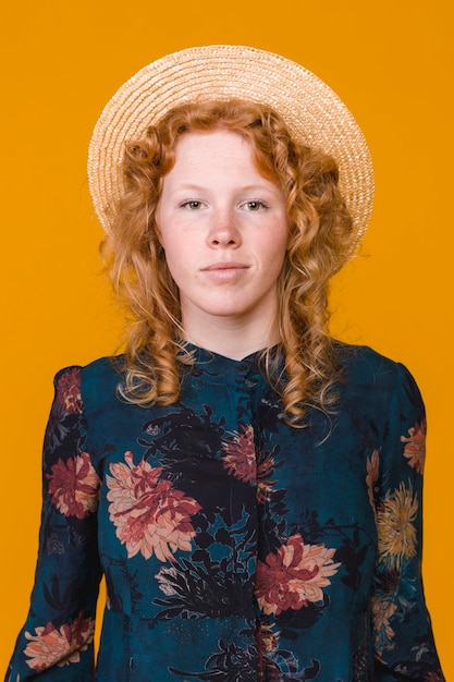 Delighted young ginger woman looking at camera