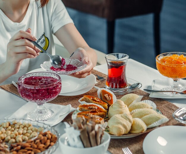 delights and black tea on the table