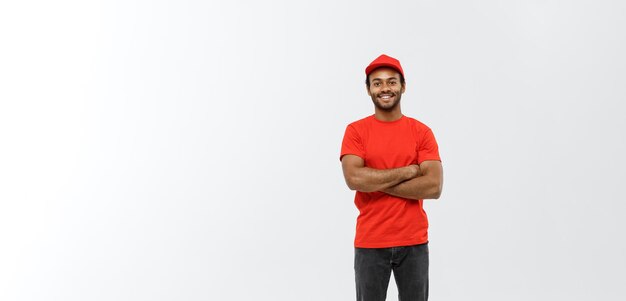 Delivery Concept Handsome African American delivery man crossed arms over isolated on Grey studio Background Copy Space