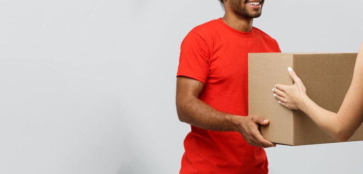 Free Photo delivery concept handsome african american delivery man giving package to homeowner isolated on gre