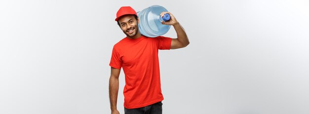 Delivery Concept Handsome African American delivery man holding water tank Isolated on Grey studio Background Copy Space