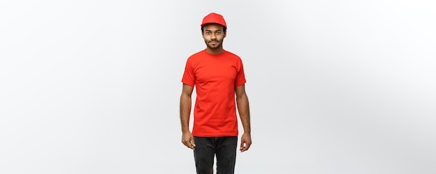 Delivery Concept Handsome African American delivery man Isolated on Grey studio Background Copy Space