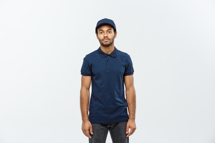 Free Photo delivery concept - handsome african american delivery man. isolated on grey studio background. copy space.