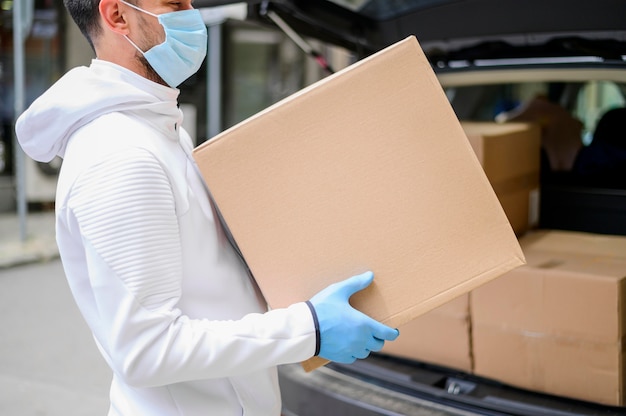 Delivery guy carrying cardboard box