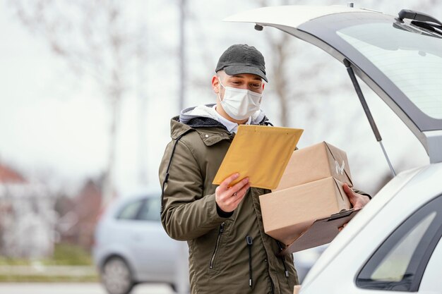 Delivery male with mask and packages