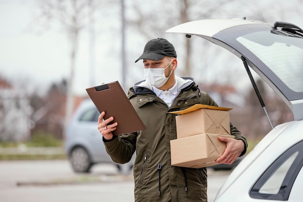 Delivery male with mask and packages