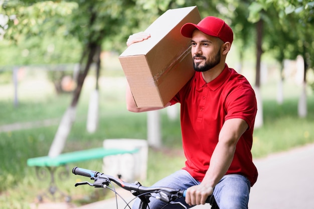 Delivery man carrying box on a bike