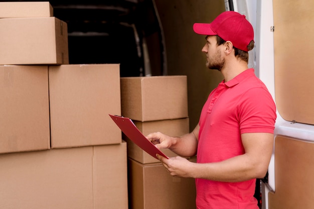 Delivery man checking packages list