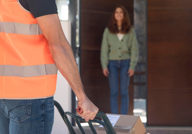 Delivery man delivering a package for a woman