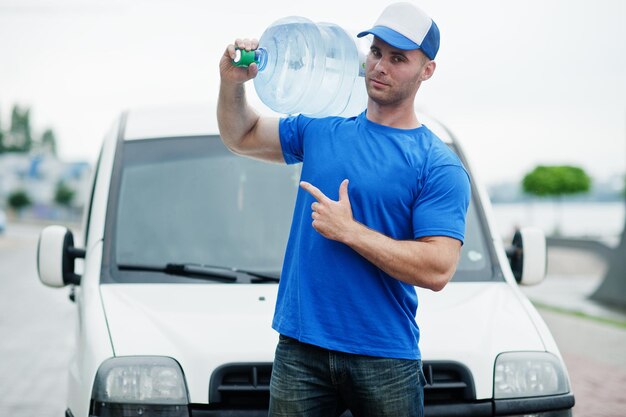 Delivery man in front cargo van delivering bottles of water showing finger