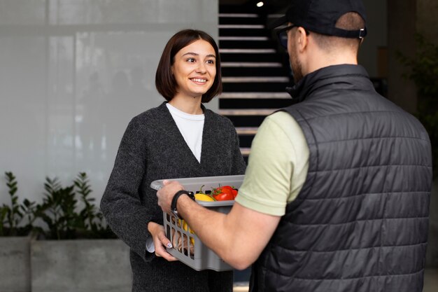 Delivery man giving groceries order to customer